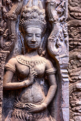 Detail of bas relief sculpture the wall of the ancient Ta Prohm temple in the Angkor Thom Area, Siem Reap, Cambodia.