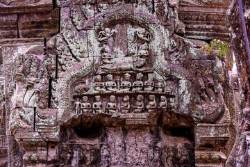 Detail of bas relief sculpture the wall of the ancient Ta Prohm temple in the Angkor Thom Area, Siem Reap, Cambodia.