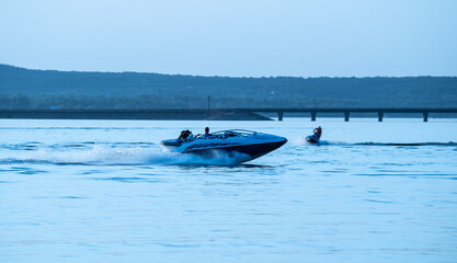 Silhouette of motorboat running on the river