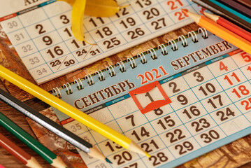 Concept background Back to school with calendar and heap of pencils.