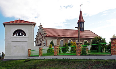 General view and architectural details of the built in 1840 together with the belfry. Classicist Catholic Church of St. Adalbert in the village of Poryte in Podlasie, Poland.