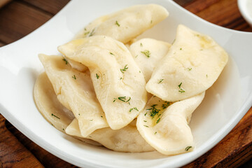 Closeup on russian vareniki dumplings on wooden background