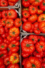 Crate of colorful organic heirloom tomatoes at the farmers market