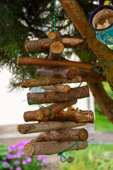 Wood decoration of radiating logs threaded on twine