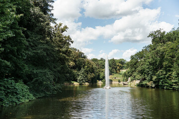 high fountain in the lake in the park