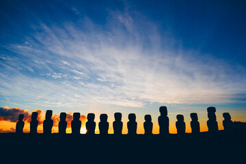 Fifteen standing moai on Ahu Tongariki against dramatic sunrise sky in Easter Island, Chile