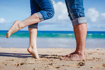 Close up of couple feet kissing on the beach