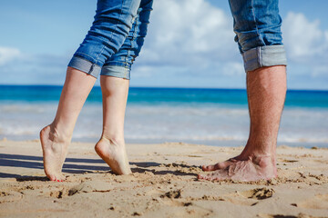 Close up of couple feet kissing on the beach