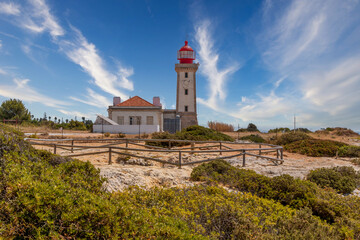 Fototapeta na wymiar Beautiful Alfanzina Lighthouse in the coastal area of Carvoeiro, Algarve - Portugal