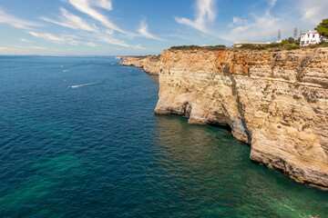 Beautiful coast line and sunny beaches in the portuguese region of Algarve. Natural caves at Carvoeiro beach, Algarve Portugal. Rock cliff arches and turquoise sea water