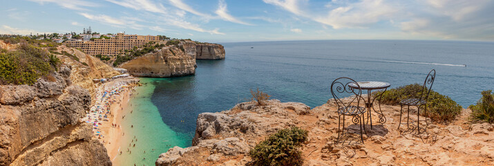 Natural caves at Centeanes beach, Algarve Portugal. Rock cliff on Centeanes beach and turquoise sea...