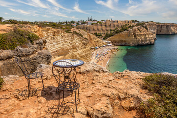 Natural caves at Centeanes beach, Algarve Portugal. Rock cliff on Centeanes beach and turquoise sea...