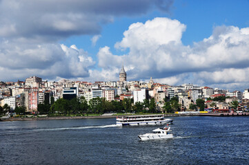 Obraz premium Panoramic view of the Bosphorus. View of the strait, ships, Galata tower and houses. 09 July 2021, Istanbul, Turkey.