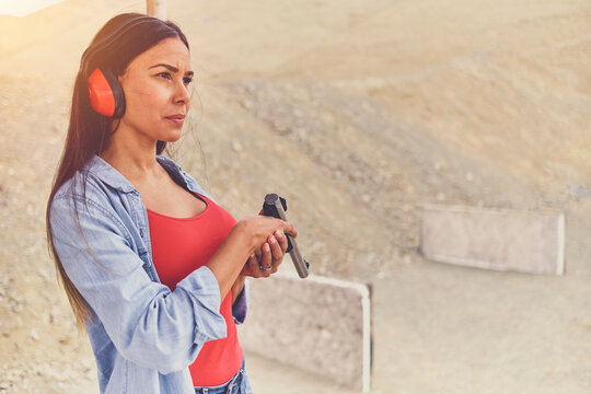 Woman releasing stress, Instructor helping woman with gun