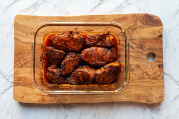 Baked meat marinated in adobo sauce top view. Turkey breast piece in brown chili marinade.