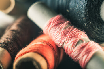 Selective focus shot of colorful thread stocks piled one on another
