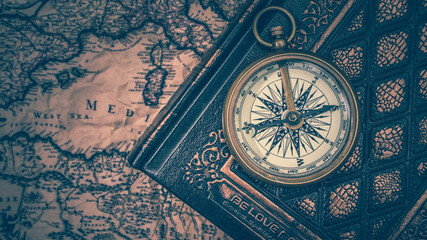 Fototapeta na wymiar Compass On Old Book And Map