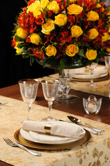 Fancy table setting with embroided tablecloth and golden sous plat