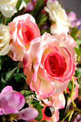 Close up of a pink plastic rose on a bouquet