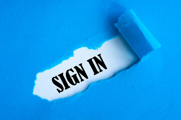 Sign in text appearing behind blue color paper