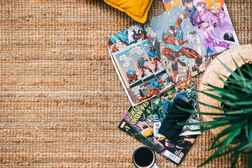 Fototapeta premium Reading comic books and manga on the carpet at cozy home. Rostov-on-Don, Russia. 22 August 2021