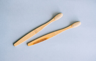 Bamboo toothbrushes making with natural materials, isolated on grey background, close-up.