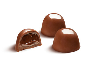 Two delicious chocolate bonbons with half showing chocolate filling, isolated