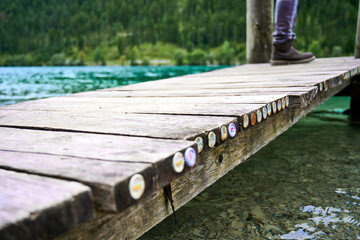 Obraz premium Bottle caps jammed at the edge of a jetty positioned above the plansee Austria. 