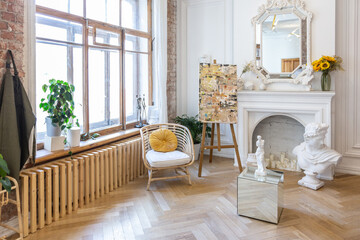 bright workshop room for the creation and work of an architect and artist in a loft style with brick walls and parquet. the walls are decorated with examples of stucco.