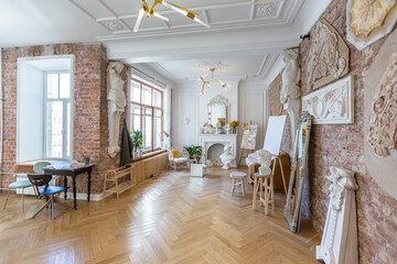 bright workshop room for the creation and work of an architect and artist in a loft style with...