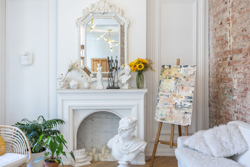 bright workshop room for the creation and work of an architect and artist in a loft style with brick walls and parquet. the walls are decorated with examples of stucco.