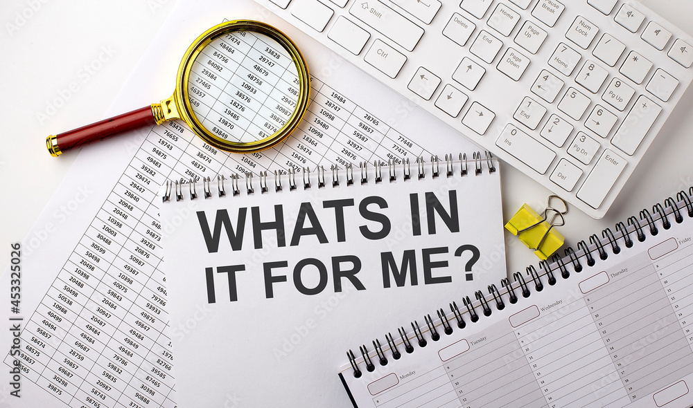 Poster whats in it for me text written on notebook on chart with keyboard and planning