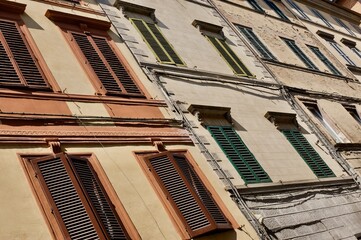 facades with coloured shutters in siena downtown
