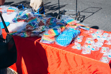 Sale of pop it, rainbow antistress toys lying on counter of street market, outdoors