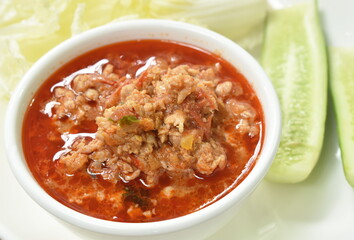 spicy chop pork with tomato and chili sauce Thai northern food  dipping fresh vegetable