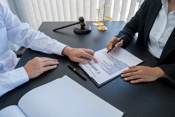  Judge gavel with Justice lawyers having team meeting at law firm background. Concepts of Law and...
