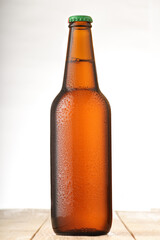 full bottle with beer in drops