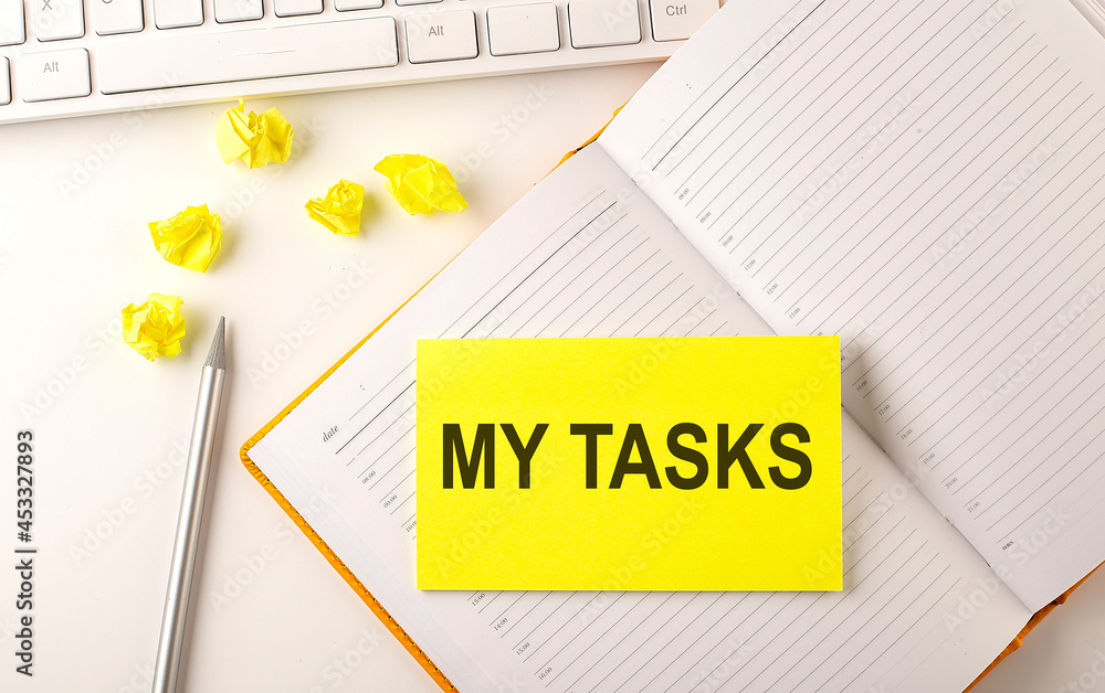 Poster my tasks text on the sticker on the diary with keyboard and pencil