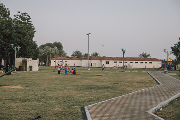 Park with Houses and People with Children in the Outdoor Yard