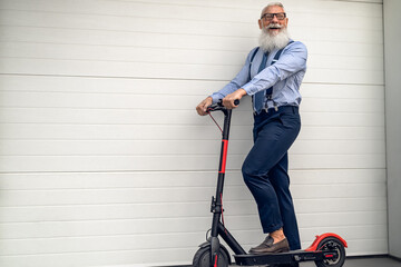 Business senior man riding to work in office with electric scooter - Eco transport concept © Alessandro Biascioli