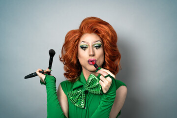 Happy drag queen having fun while doing makeup in studio