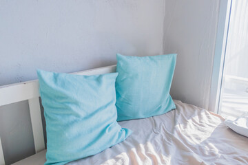 Two pillows and a wooden sofa