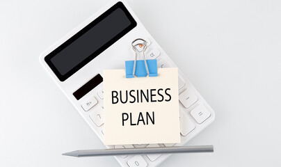 Business plan text on the sticker on white calculator