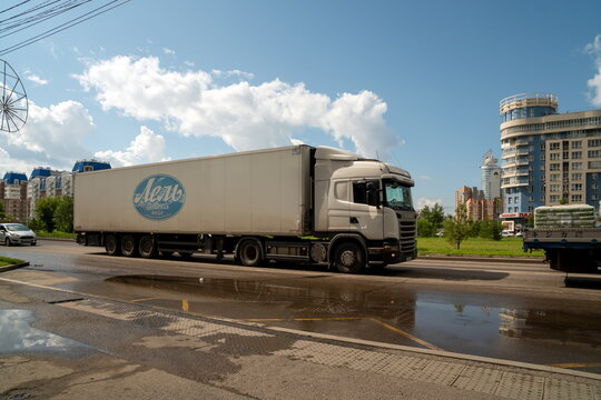 Krasnoyarsk, Krasnoyarsk Region, RF - July 20, 2021: A large lorry, with an inscription in Russian - Drinking water Lel, is driving along a city street after a rain in summer.