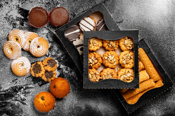 Top view different cookies in box on table top, Flat lay of cookies on black background, Prepared cookies food buffet on table for serve
