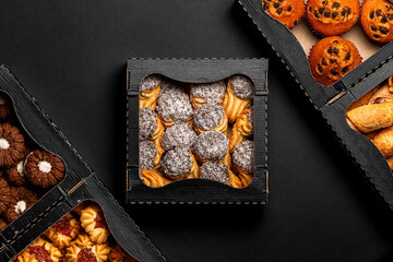 Top view different cookies in box on table top, Flat lay of cookies on black background, Prepared cookies food buffet on table for serve