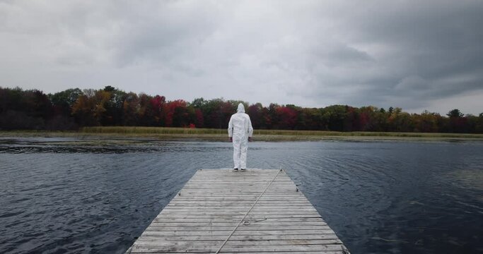 Fourth Wave Delta Variant: lockdown hazardous material suit during the fall season as virus rages causing fear and anxiety