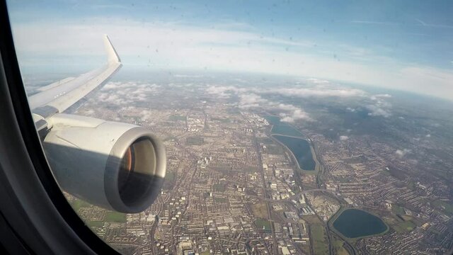 Airplane engine and wing view on approach to London airport
