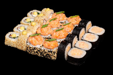 Japanese food: maki and nigiri sushi set on black background. side view composition.