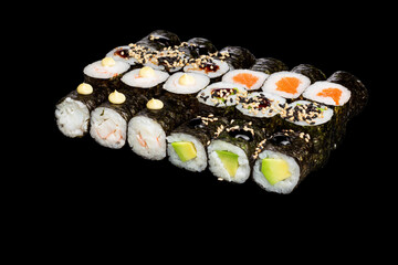 Japanese food: maki and nigiri sushi set on black background. side view composition. © Serhii